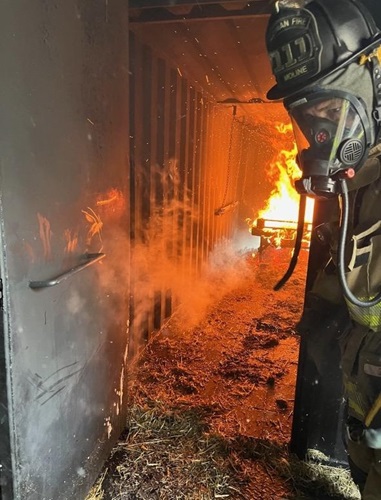 Firefighter in burning building with fire