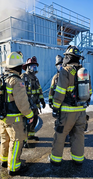 Fire Captain talking with recruits in full gear