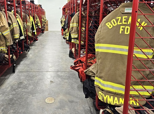 Inside the fire station locker room with turnout gear hanging from lockers