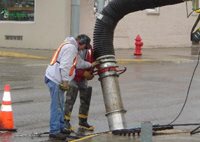 men working on a storm drain