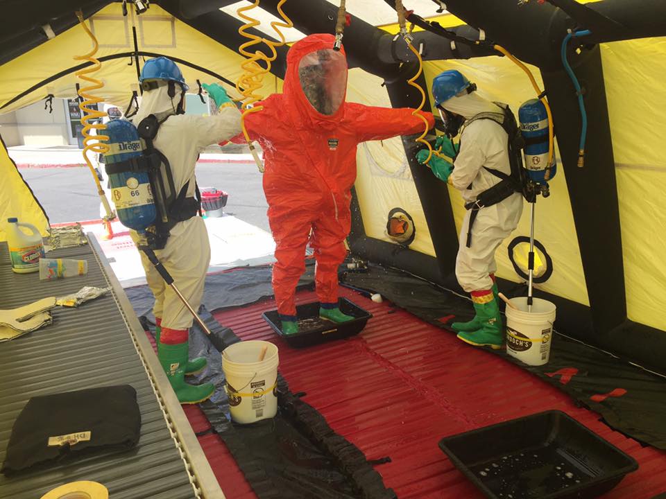 Image of Hazmat workers inside Hazmat tent